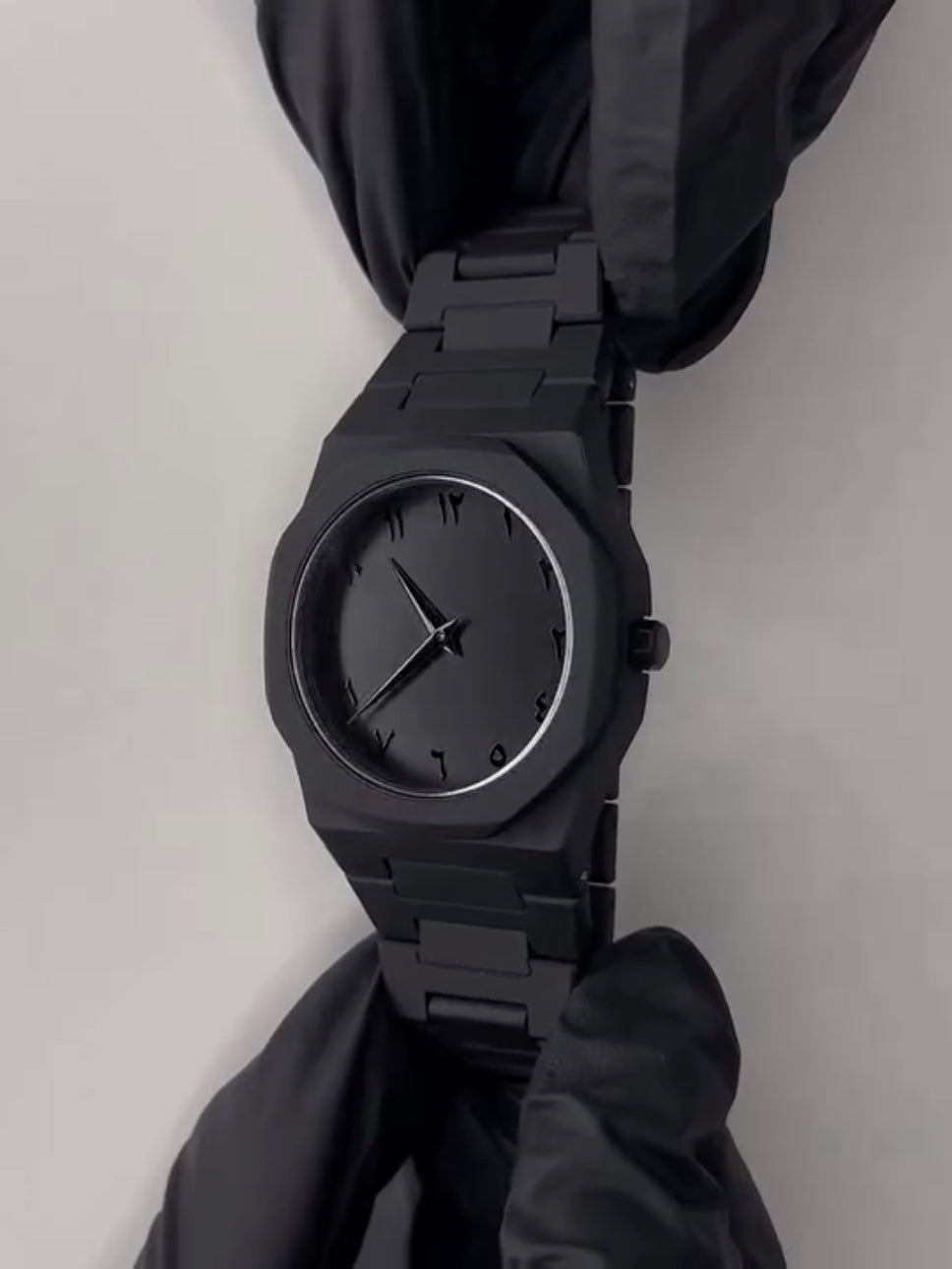 Close-up of the watch showing the sleek integrated metal strap and secure butterfly clasp