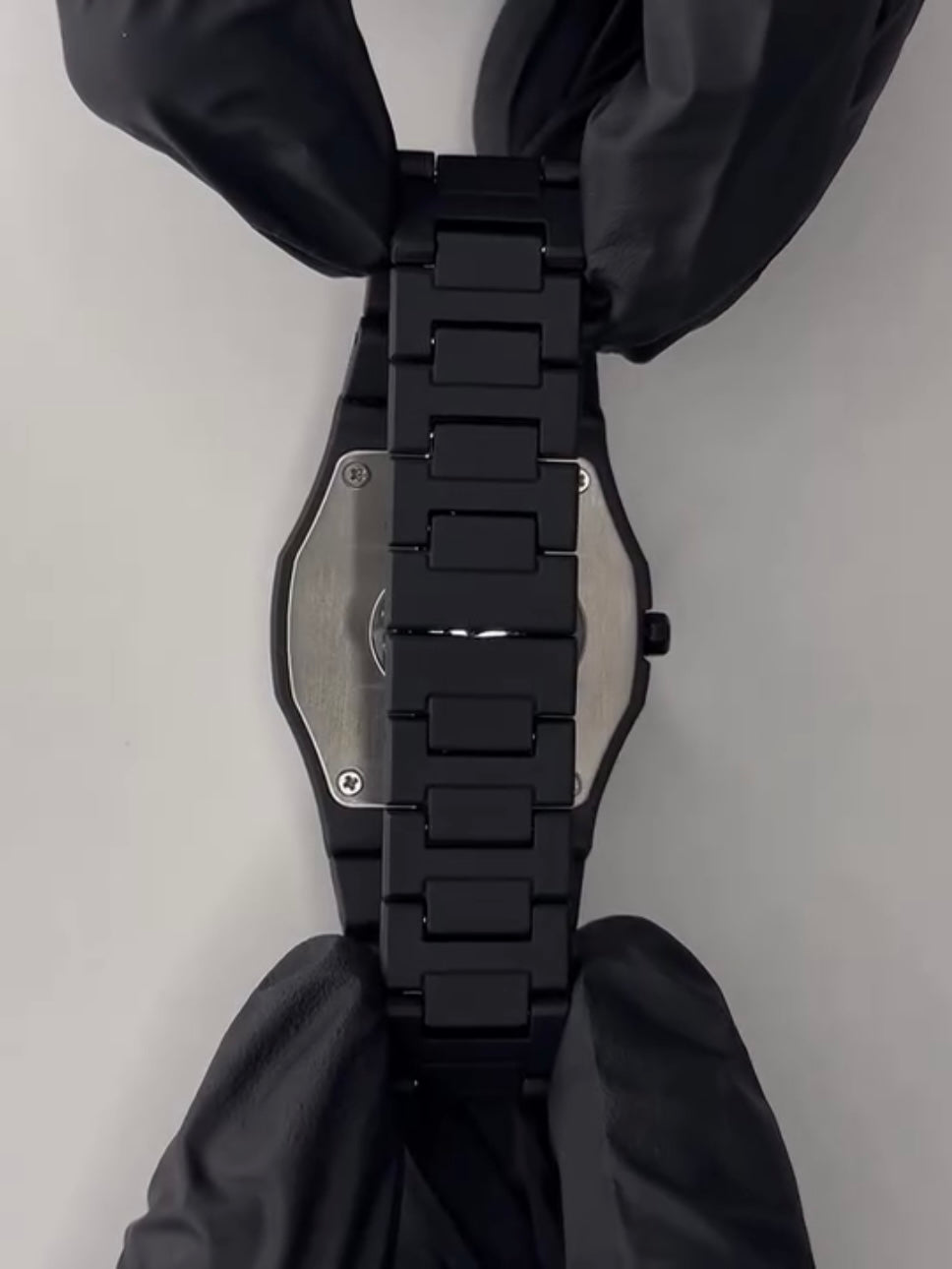 Side view of the black analog wristwatch highlighting its modern minimalist design
