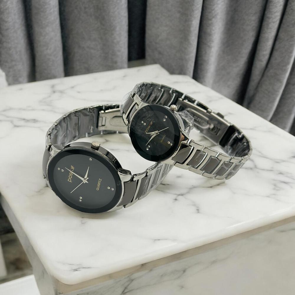 Close-up of two coordinated watches side by side